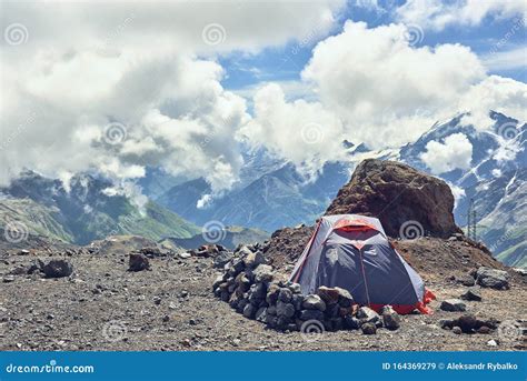 Tent Climbers In The Mountains Against The Backdrop Of Mountain Peaks