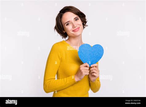 Photo Of Cute Brunette Millennial Lady Hold Heart Wear Yellow Shirt Isolated On Grey Color