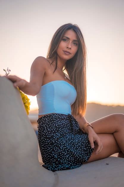 Premium Photo Lifestyle Portrait Of A Pretty Brunette In A White Top Sitting On The Walk