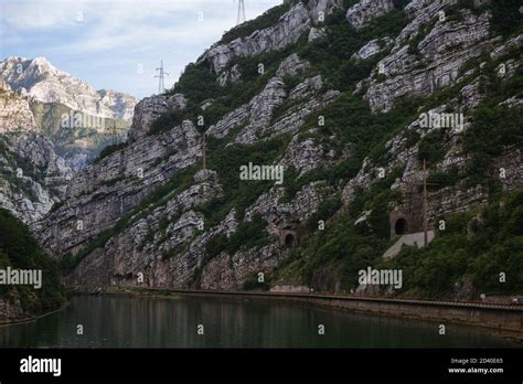 River Surrounded By Rocky Mountains Covered In Greenery In Mostar