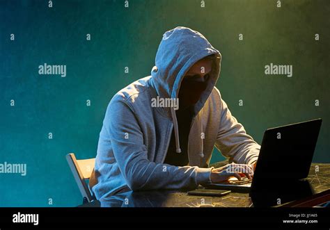 Hooded Computer Hacker Stealing Information With Laptop Stock Photo Alamy