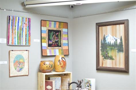 Art Work Displayed On The Wall Next To Other Artwork And Decor Items In