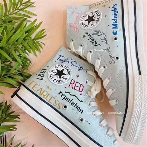 Someone Has Painted Their Converse Sneakers With The Words Fearless And