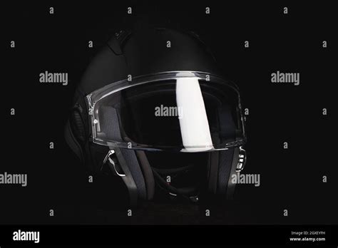 Black modular motorcycle helmet on black background Stock Photo - Alamy