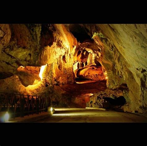 The Inside Of A Cave With Lights Shining On It S Walls And Caves In The