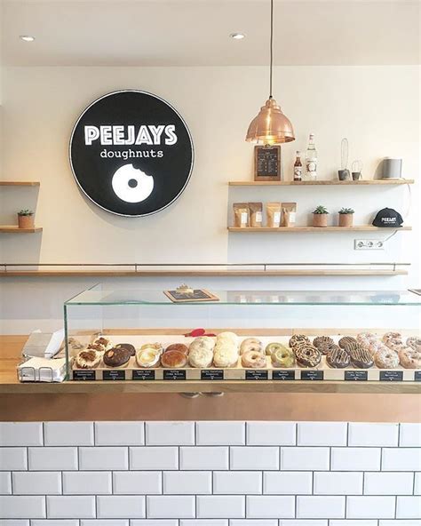 A Display Case Filled With Donuts In Front Of A Sign That Says Pejays