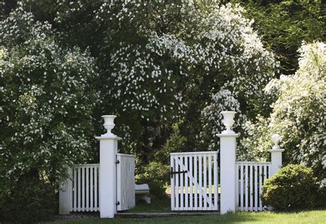 Placing Plant Potters On The Top Of Fence Posts Brings A Bit Of Life To