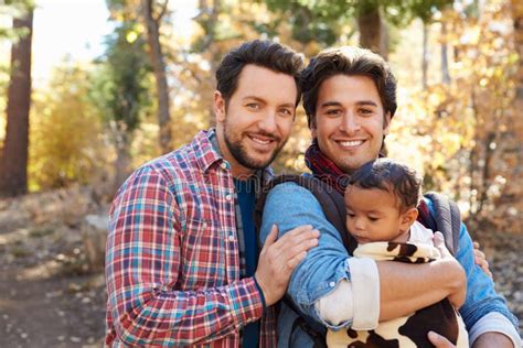 Coppie Maschii Gay Con Il Bambino Che Cammina Attraverso Il Terreno Boscoso Di Caduta Immagine