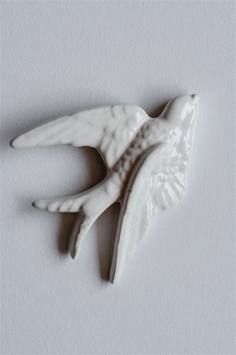 A White Bird Figurine on White Surface · Free Stock Photo