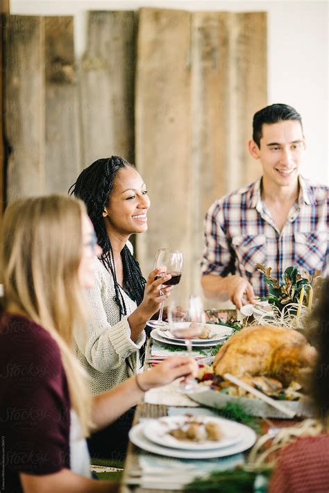 "Friends Enjoying A Thanksgiving Feast" by Stocksy Contributor "CWP ...