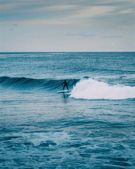 Water Person Surfing On Sea Waves During Daytime Blue Image Free Photo