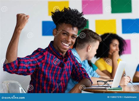 Cheering African American Male Student at Computer with Group of ...