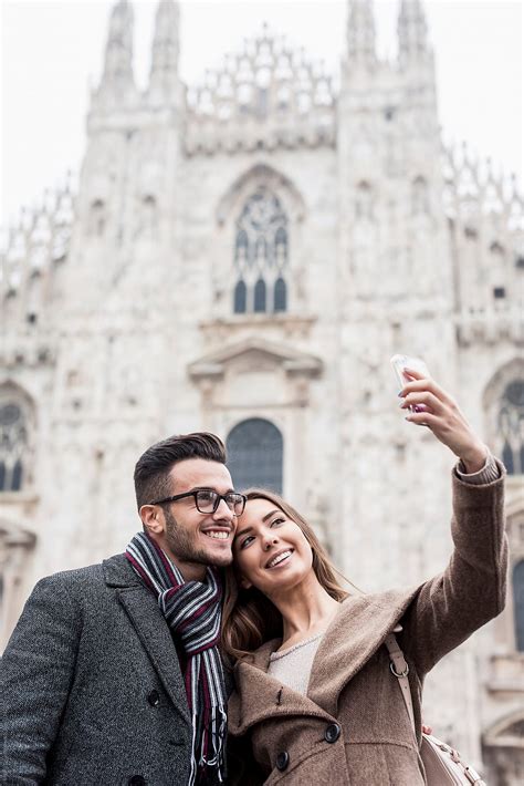 Smiling Couple Taking A Selfie In Milan Italy By Stocksy