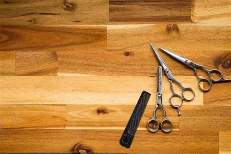 Premium Photo | Stylish professional barber scissors on wood background ...