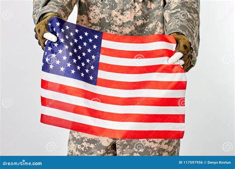 Soldier Holding American Flag. Stock Photo - Image of gear, army: 117597956