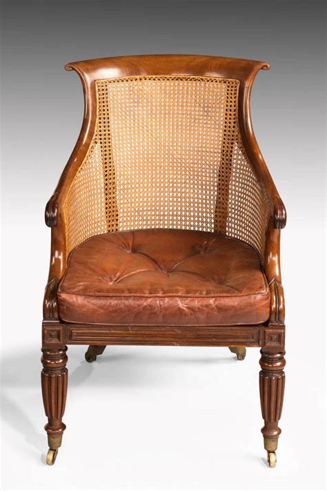 Pair Of Regency Period Bergere Library Chairs With Swept Arms At 1stdibs