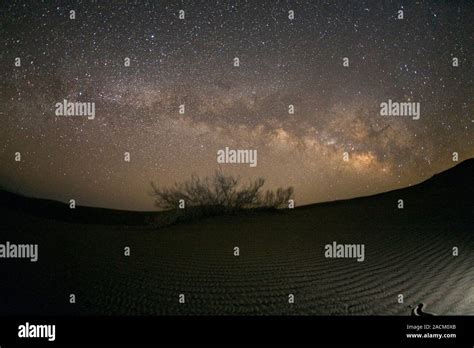 Milky Way Over A Desert Dust Lanes And Glowing Nebulae Are Seen Along