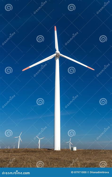 Wind Turbines Against A Blue Sky Generating Electricity Stock Photo