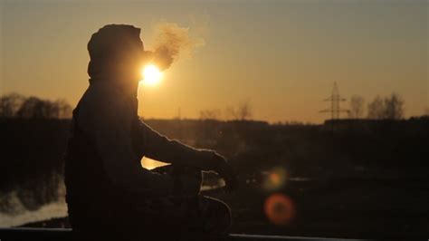 Man In Profile Sunset Smoking Electronic Cigarette Stock Footage