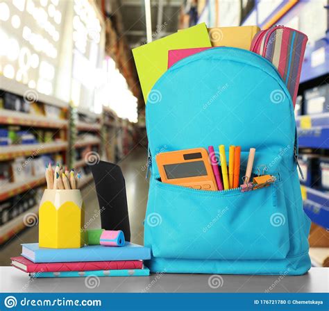 Bright Backpack With School Stationery On Table In Mall Stock Photo