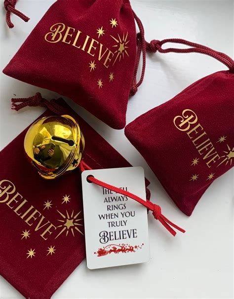 Three Red Velvet Bags With Gold Bells On Them One Has A Believe Tag