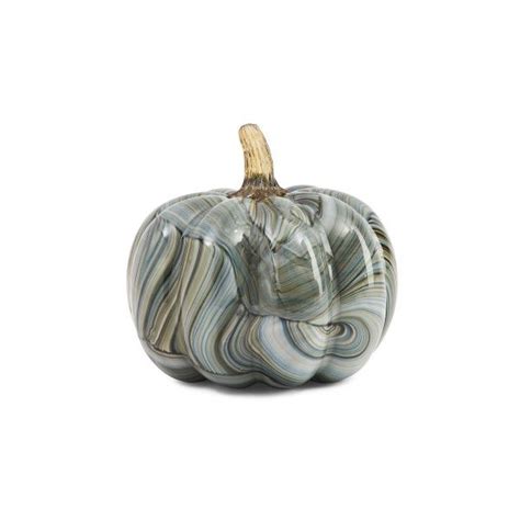 A Marbled Glass Pumpkin Sitting On Top Of A White Table