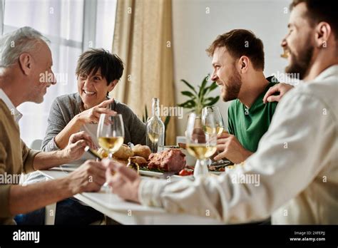 A Gay Couple Enjoys Dinner With Parents At Home Stock Photo Alamy