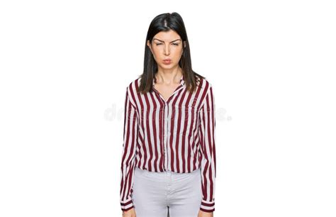 Beautiful Brunette Woman Wearing Striped Shirt Puffing Cheeks With