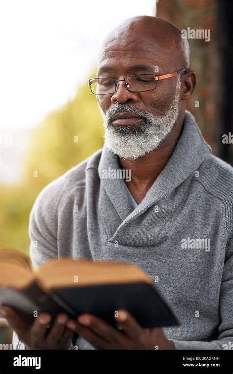 Studying The Scriptures A Handsome Senior Man Reading His Bible While