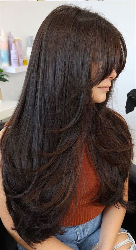  1. Long Layers with Side-Swept Bangs 