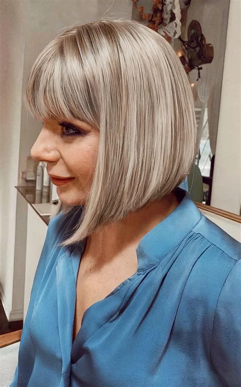 1. Layered Bob with Angled Bangs: