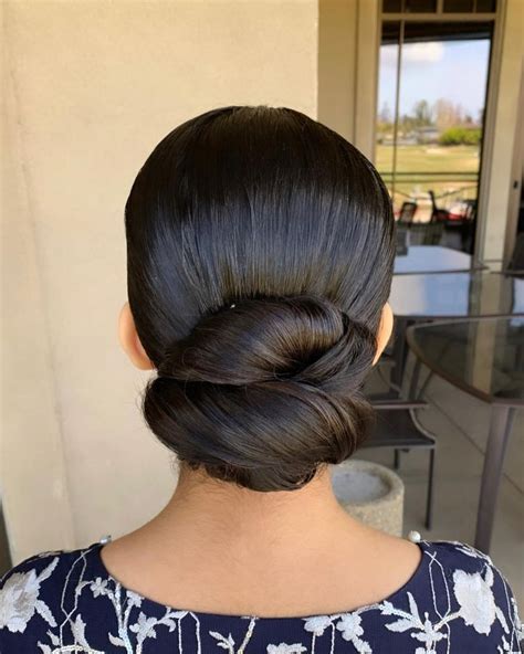 1. Low Chignon with Twisted Layers: