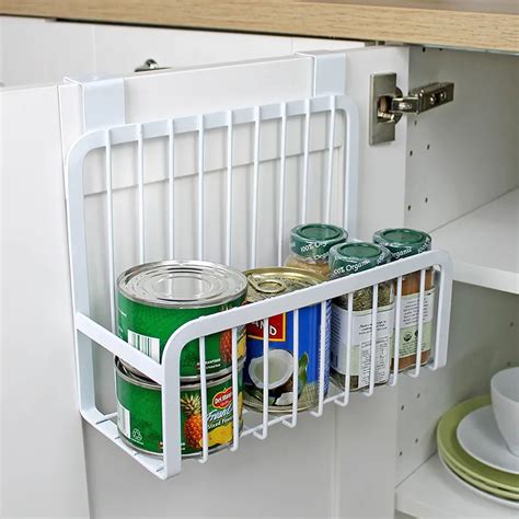 Hang baskets from the back of the cabinet door: