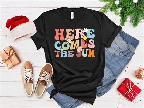 Here Comes the Sun T-Shirt: A Symbol of Summer, Optimism, and Joy