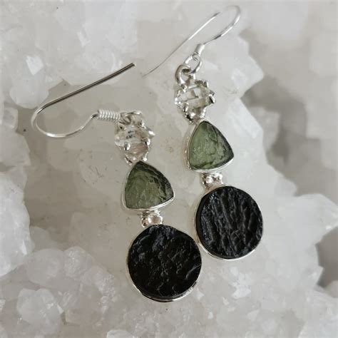 Immerse yourself in the enigmatic beauty and transformative energy of moldavite earrings.