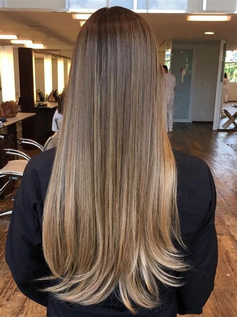 Long, straight hair with light ash brown highlights.