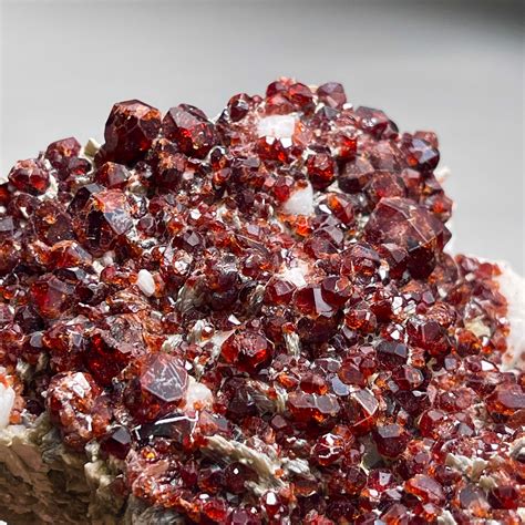 Natural Spessartine Garnet in Matrix: A Radiant Gemstone within Nature's Embrace