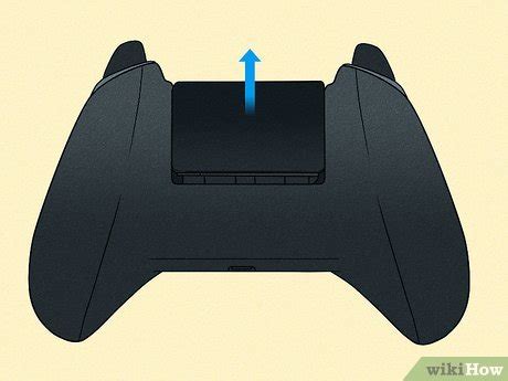 Remove the battery cover from the back of the controller.