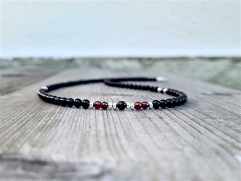 Use black onyx and garnet stones: