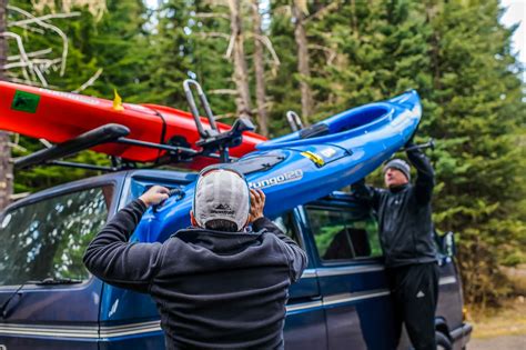 Yakima JayLow based kayak trailer for 4 kayaks stored upright beside a house