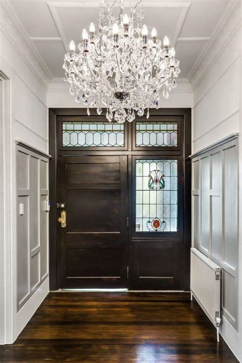 Small entry with a mini crystal chandelier creating a welcoming glow
