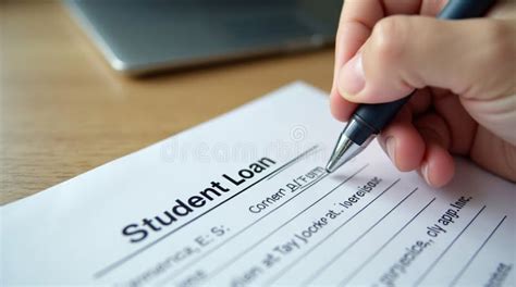 A close-up shot of a hand carefully signing a student loan document with a pen, representing the formal commitment and significant financial responsibility associated with higher education funding.