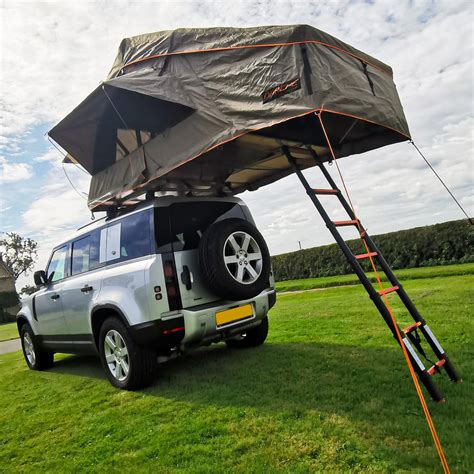 land rover with tent on roof