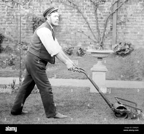 man and old mower black and white