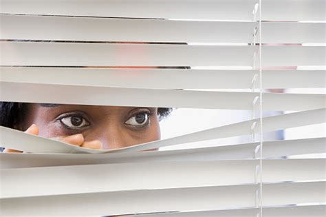 office watching through blinds