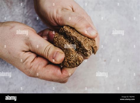 person breaking cookie in half