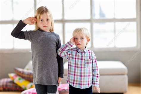 sister and brother standing next to each other