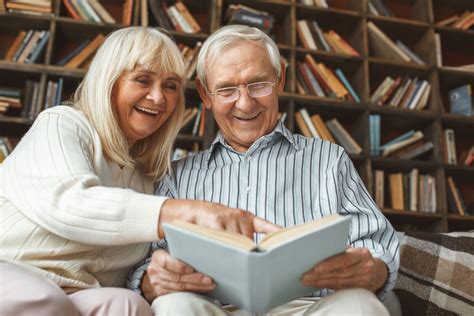 someone reading a book to an old person