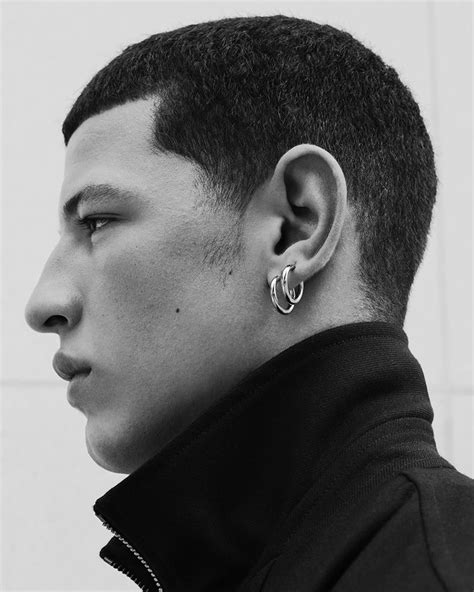 two earrings on a guy