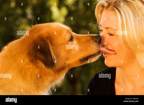 women kisses dog